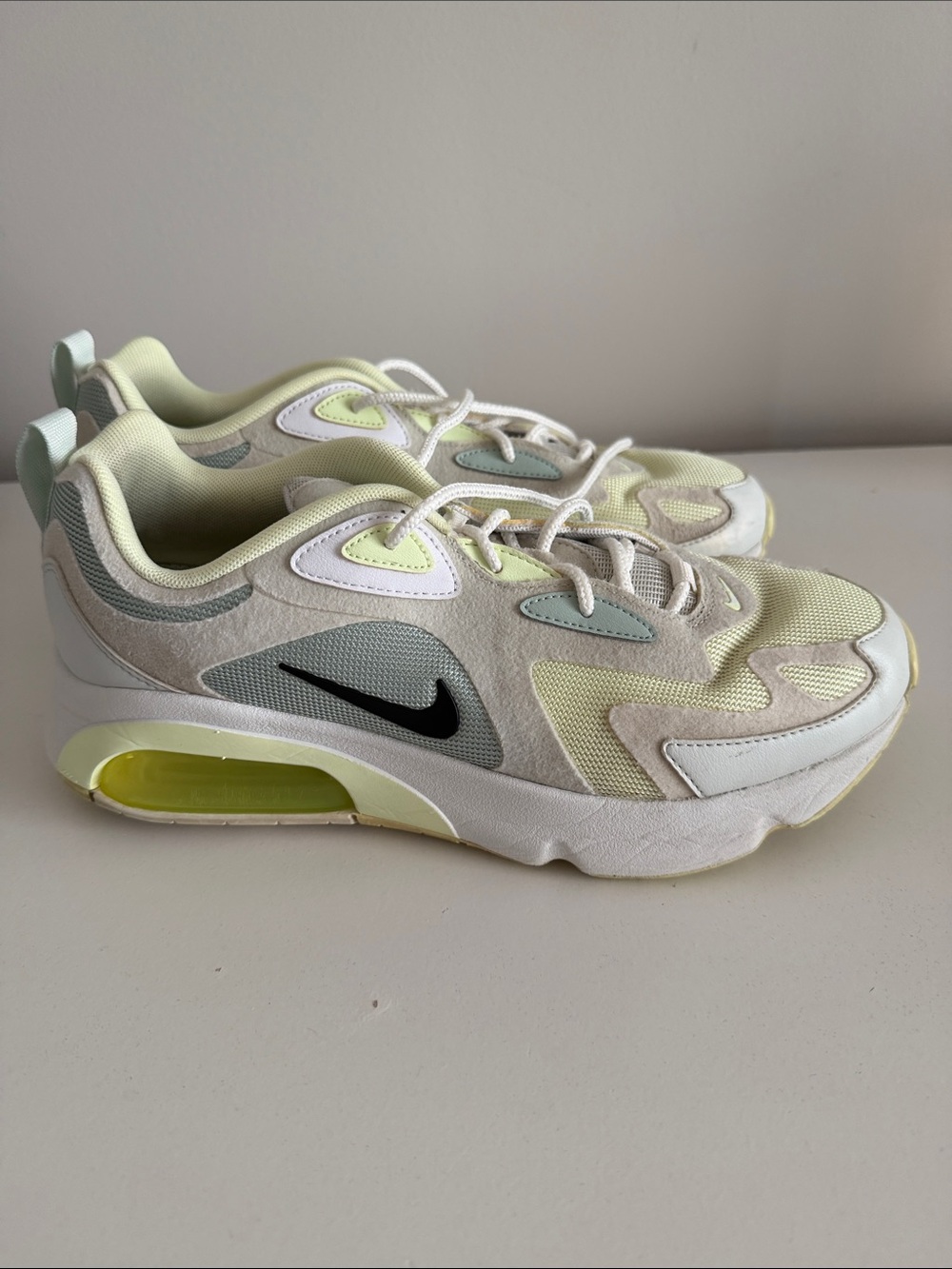 Nike women’s Sneakers in Pale Yellow, White & Black Swoosh